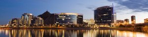 City over the water view at night | Farrmont Realty Group